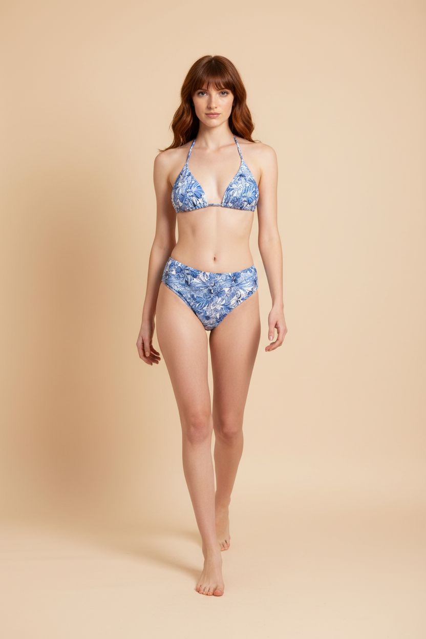 Blue palm 3‑piece bikini set on model with high‑leg bottom and wrap skirt by Orixah