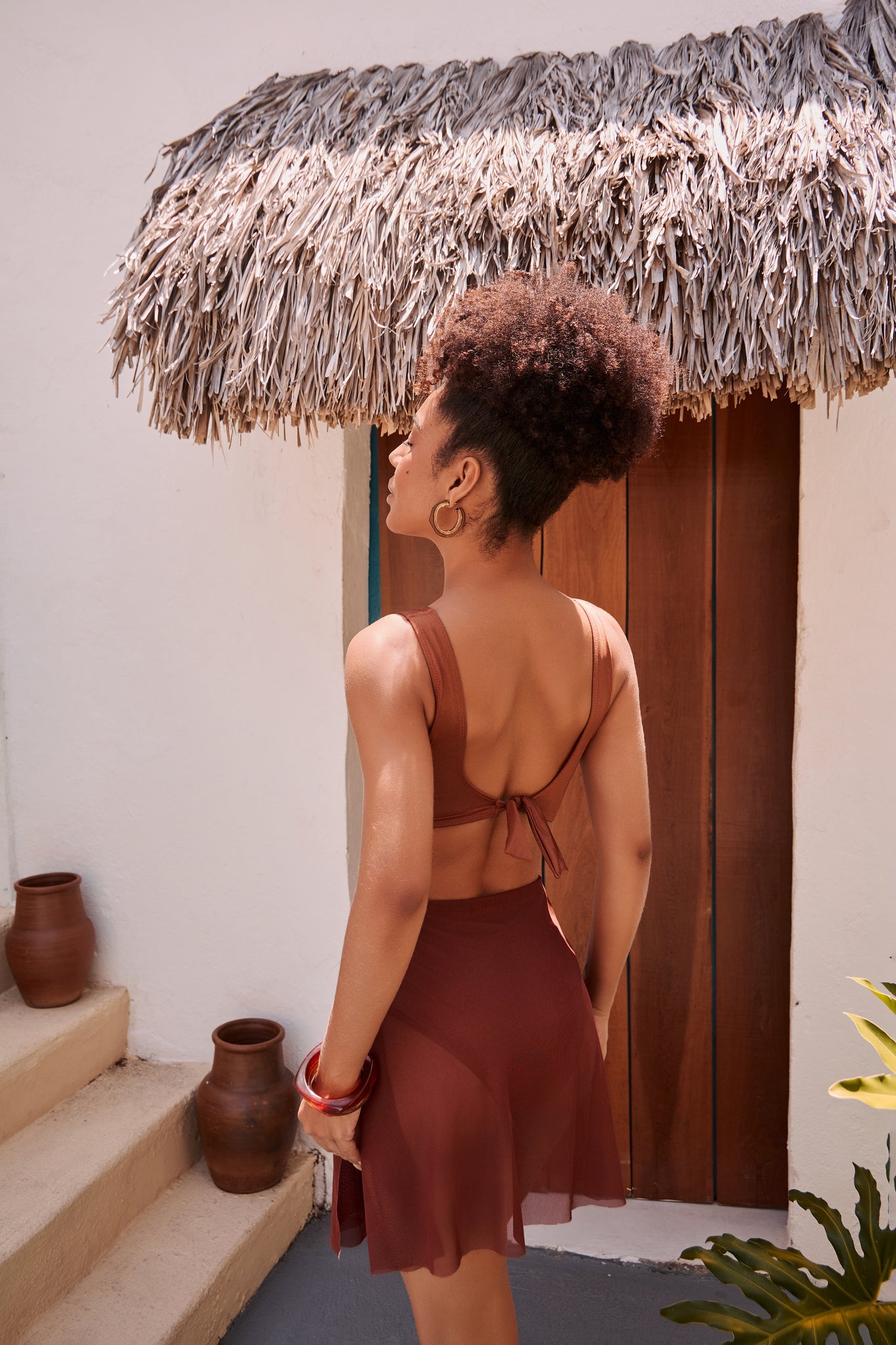 Orixah Suntrail Resort Set in rust with tied-back crop top and wrap skirt, rear view